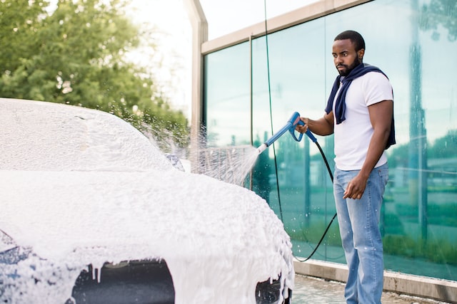 outdoor cleaning of the car with soap foam