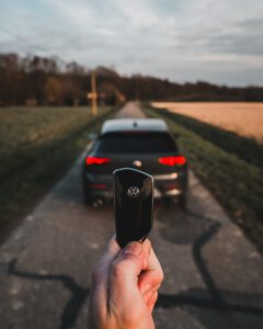 person holding black key during daytime