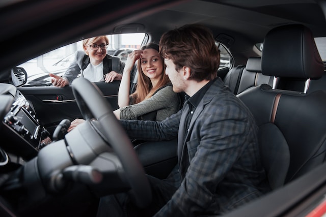 persons sitting in dealership car