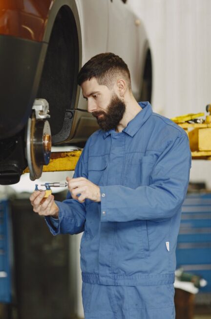 a-man-fixing-the-car-brakes